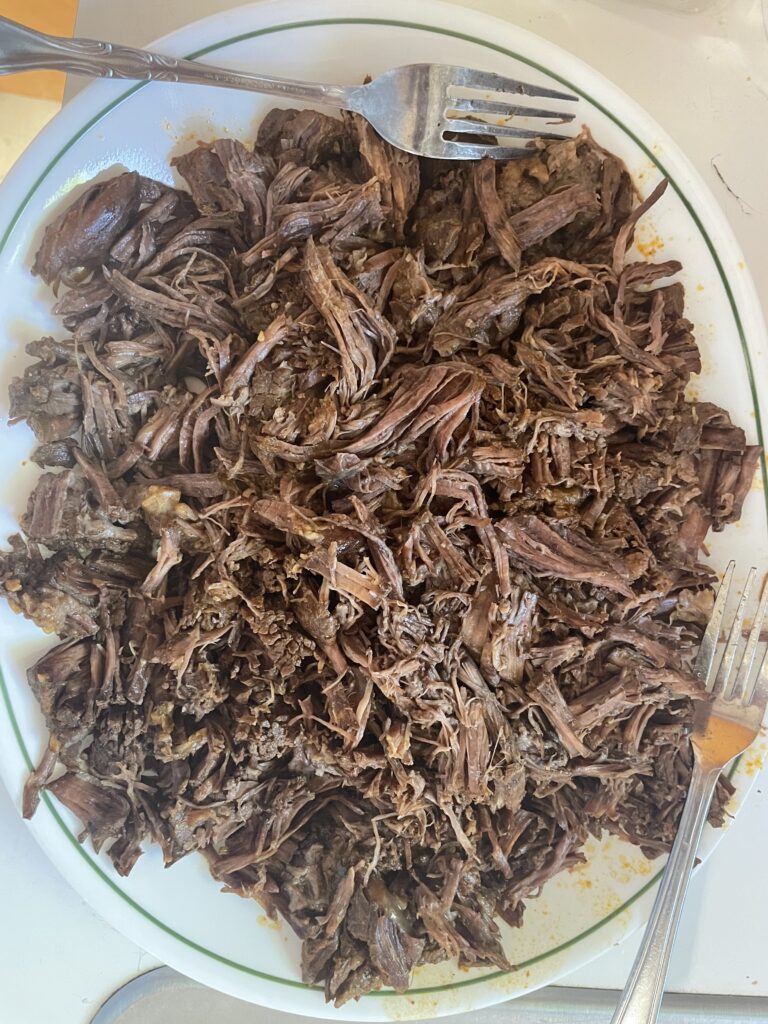 Shredded Birria Meat with forks after cooking